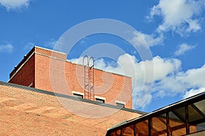 Old red brick building with metal ladder to roof