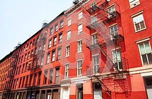 Old red brick buildings with fire escapes, New York City, USA