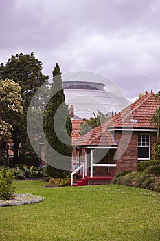 Old red brick buildings with garden, palm trees and gazeboes