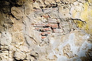 Old red brick in cracked concrete wall