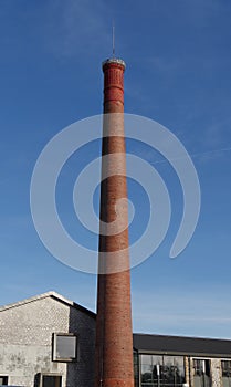 Old red brick factory chimney