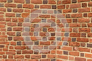 Old red brick fortress wall with gray cement mortar textute