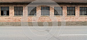 Red brick industrial building with large windows