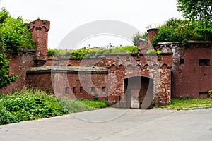 An old red brick military fort. Old tower of red brick. Old military fortification.