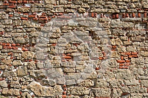 Old red brick wall background. Texture of an ancient stone wall. Stonewall background