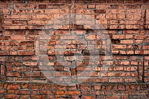 Old red brick wall with cracks and scratches. Horizontal wide brickwall background. broken bricks texture. House facade