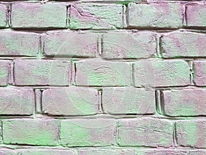Old red brick wall with damaged red and green paint layer, closeup background photo texture. Seamless composition