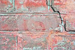Old red brick wall with fissure, grunge texture background