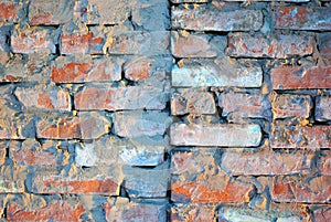 Old red brick wall with fissures, grunge texture background