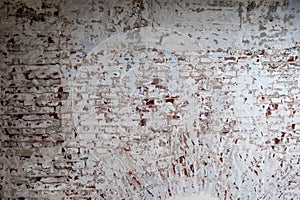 Old red brick wall peeling off the white painted color. Background