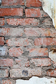 Old red brick wall with plaster