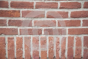 Old red brick wall with rich colorful grainy texture and details