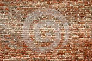 Old red brick wall texture background in sunlight