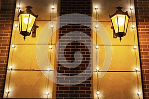 Old red brick wall with two spotlights. Light around. Background texture closeup