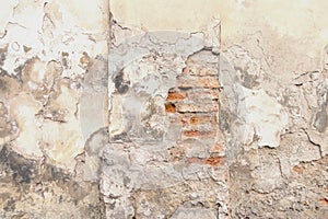 Old red brick and white plaster wall with cracked shabby surface texture background.