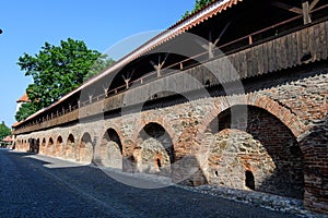 Old red bricks defence wall on Strada Cetatii Citadel Street in the historical center of the Sibiu city in Transylvania