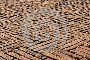 Old red bricks paving zigzag pattern