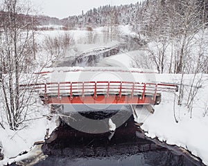 Old red bridge in winter