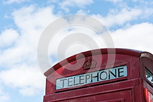 An old red british telephone booth close up