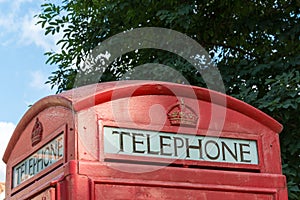 An old red british telephone booth close up