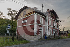 Old red building of Besiny station with railway in autumn evening