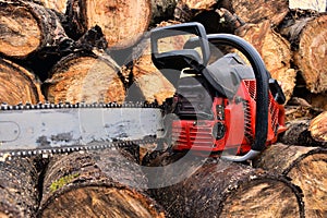 Old Red Chainsaw and Cut Firewood