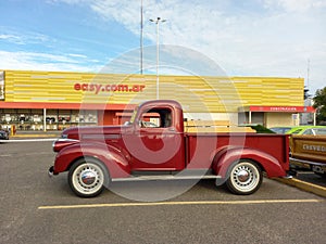 Old red 1946 Chevrolet Chevy AK series 250 pickup truck in a parking lot at a classic car show.