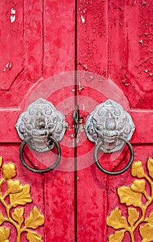 Old red chinese temple door with crave leaf photo