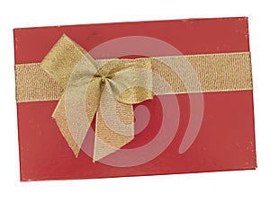Old red Christmas or Valentine gift box with gold ribbon bow, isolated on white background. Last year`s romance. Top