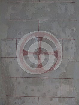 Old red circle and cross knights templar symbol wall church