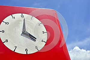 Old red clock with clockface