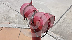 Old red closeup firehydrant with chain