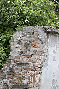 Old red color brick wall with plaster.