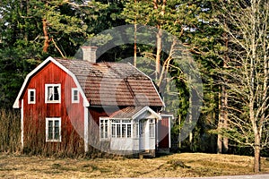 Old red cottage in a rural surrounding
