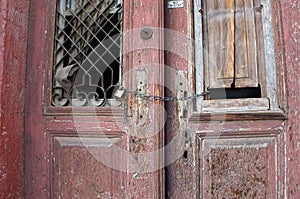 Old red door in ruin