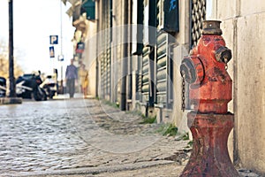 Old red fire hydrant on the street