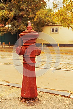 Old red fire hydrant water pipe near the road