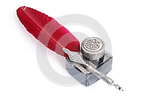 Old red fountain pen with inkwell on white background