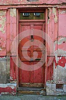 Old red front door with peeling paint