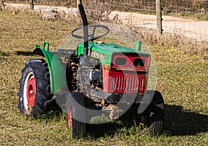 Old Red and Green Farm Tractor in Long Grass