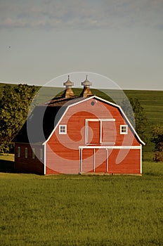 Old red hip roofed barn front