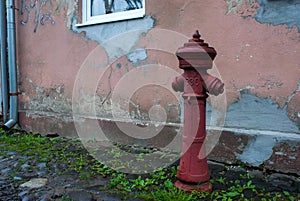 Old red hydrant. Vintage fire hydrant.