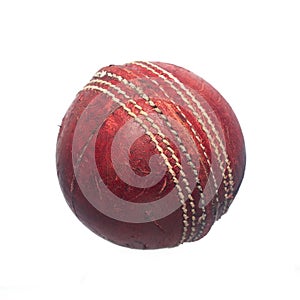 Old red leather cricket ball isolated against a white background.