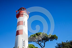 Old red lighthouse in La Rochelle harbor, France