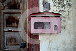 Old red mailbox on wall