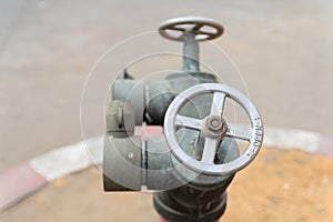 Old red metallic fire hydrant plug