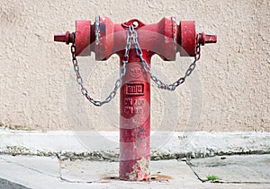 Old red metallic fire hydrant on street