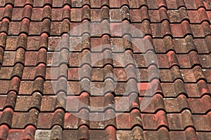 Old red and orange weathered roof tiles texture