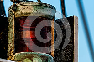 Old red port side lantern on a ship