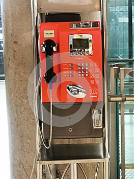 Old red public phone booth Coin operated type in Thailand